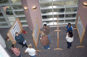 A group of people looking at research posters