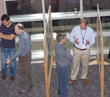 A group of people looking at research posters