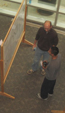 Two people looking at a research poster