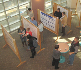 A group of people looking at a research poster