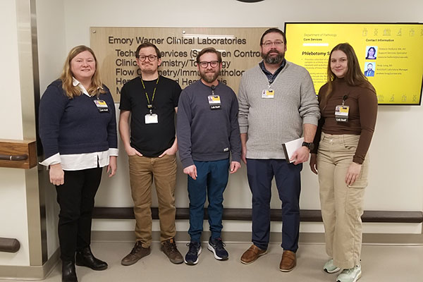 The five members of the mailouts team standing together