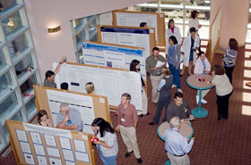 A group of people looking at research posters