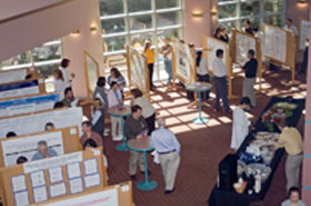 A group of people looking at research posters