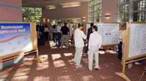 A group of people looking at research posters