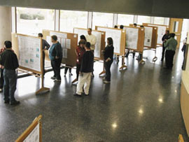 A group of people looking at research posters