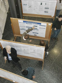 A group of people looking at research posters