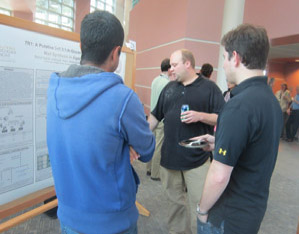 A group of people looking at a research poster