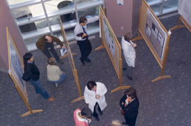 A group of people looking at research posters