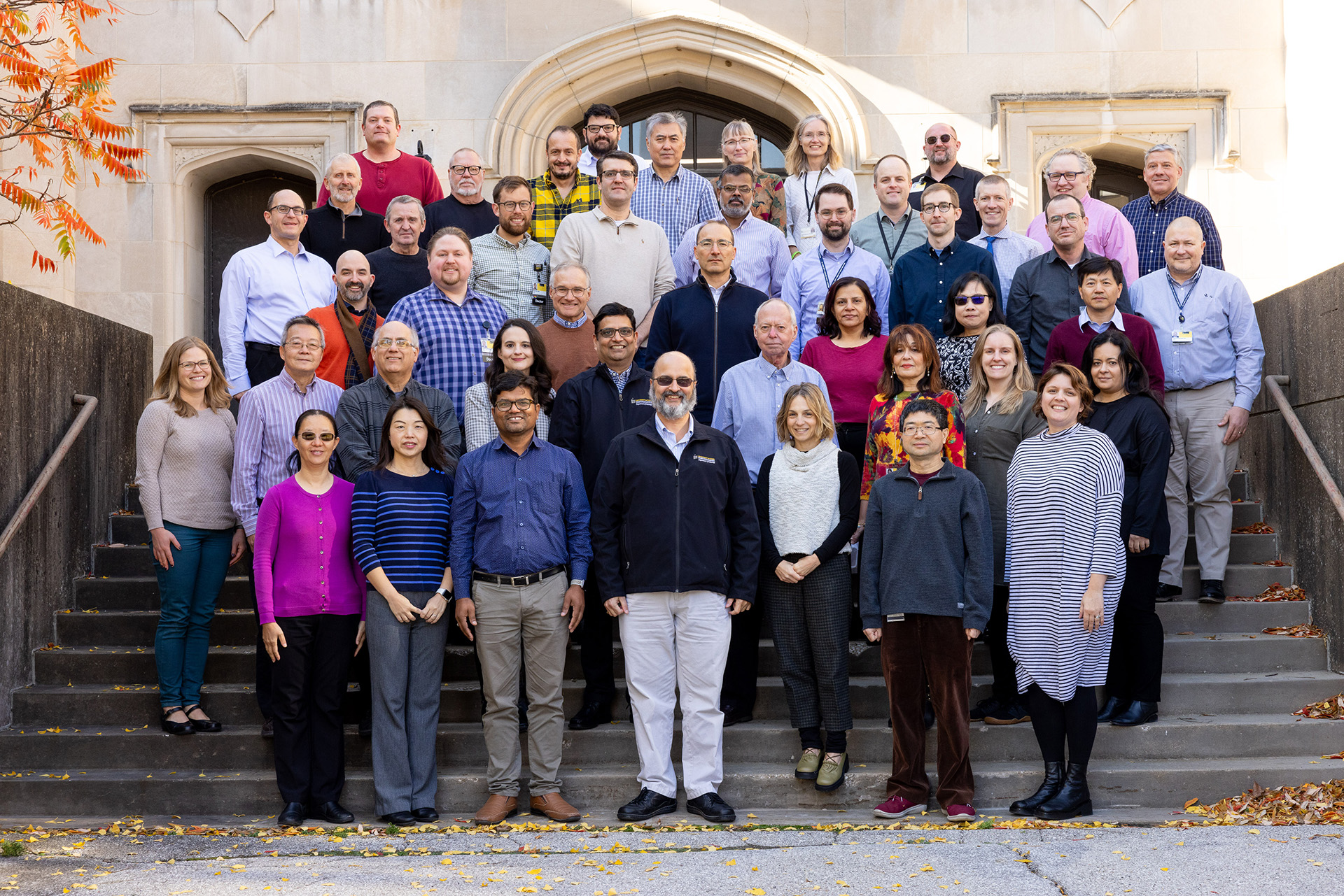 Pathology faculty standing on the stairs outside of the medical research labs