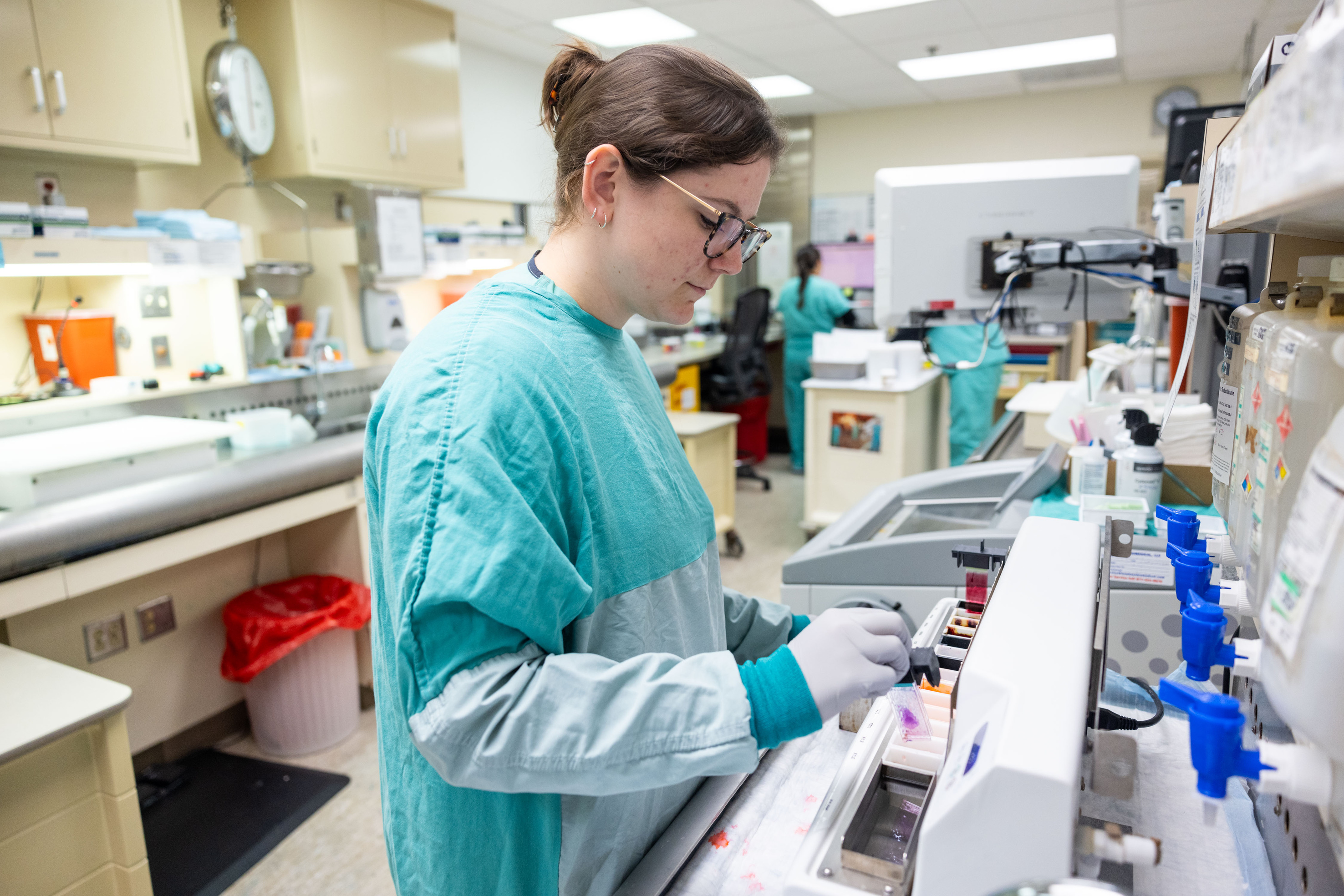 Lab technician uses a linear rapid stainer 