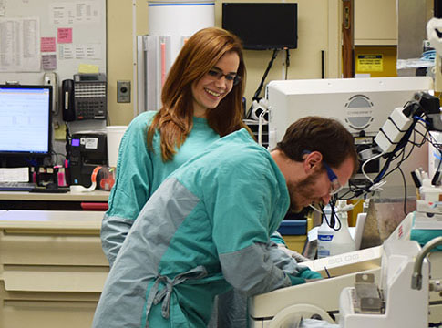 Two people in scrubs working in the Surgical Pathology Lab