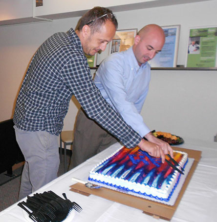 Drs. Badovinac and Bellizzi cutting cake