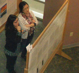 Two people looking at a research poster