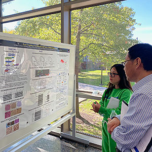Two people looking at a research poster