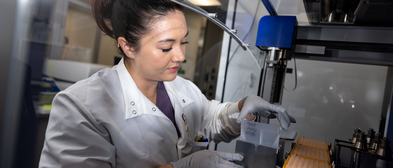 A medical lab scientist works with an epMotion liquid handler in the molecular pathology lab 