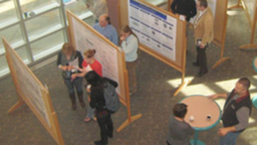 A group of people looking at a research poster
