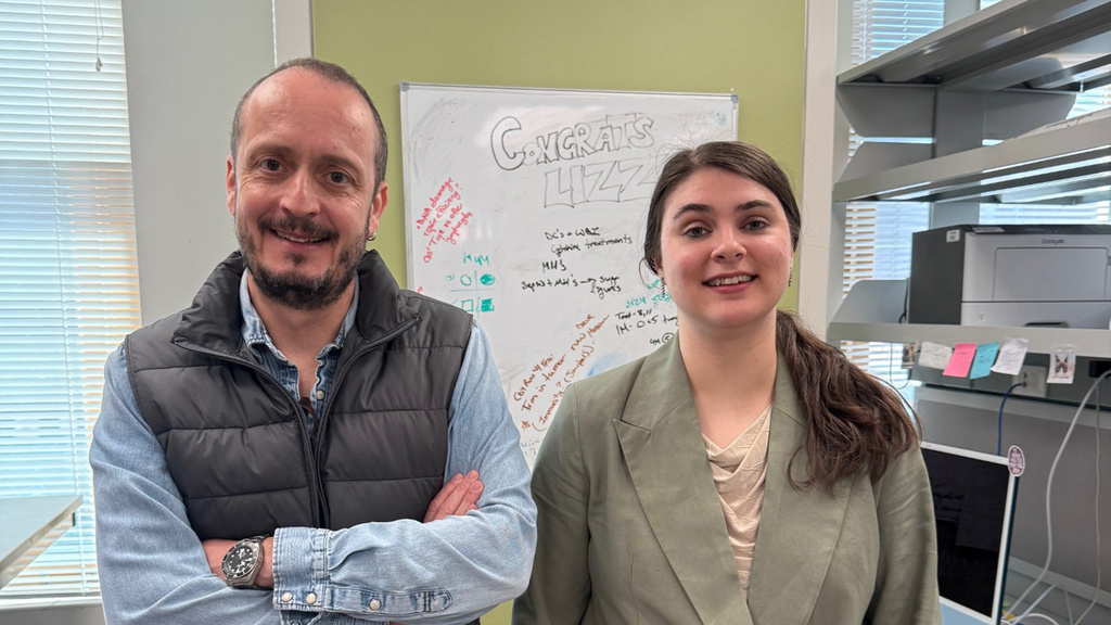 Dr. Badovinac and Liz standing in a lab, smiling