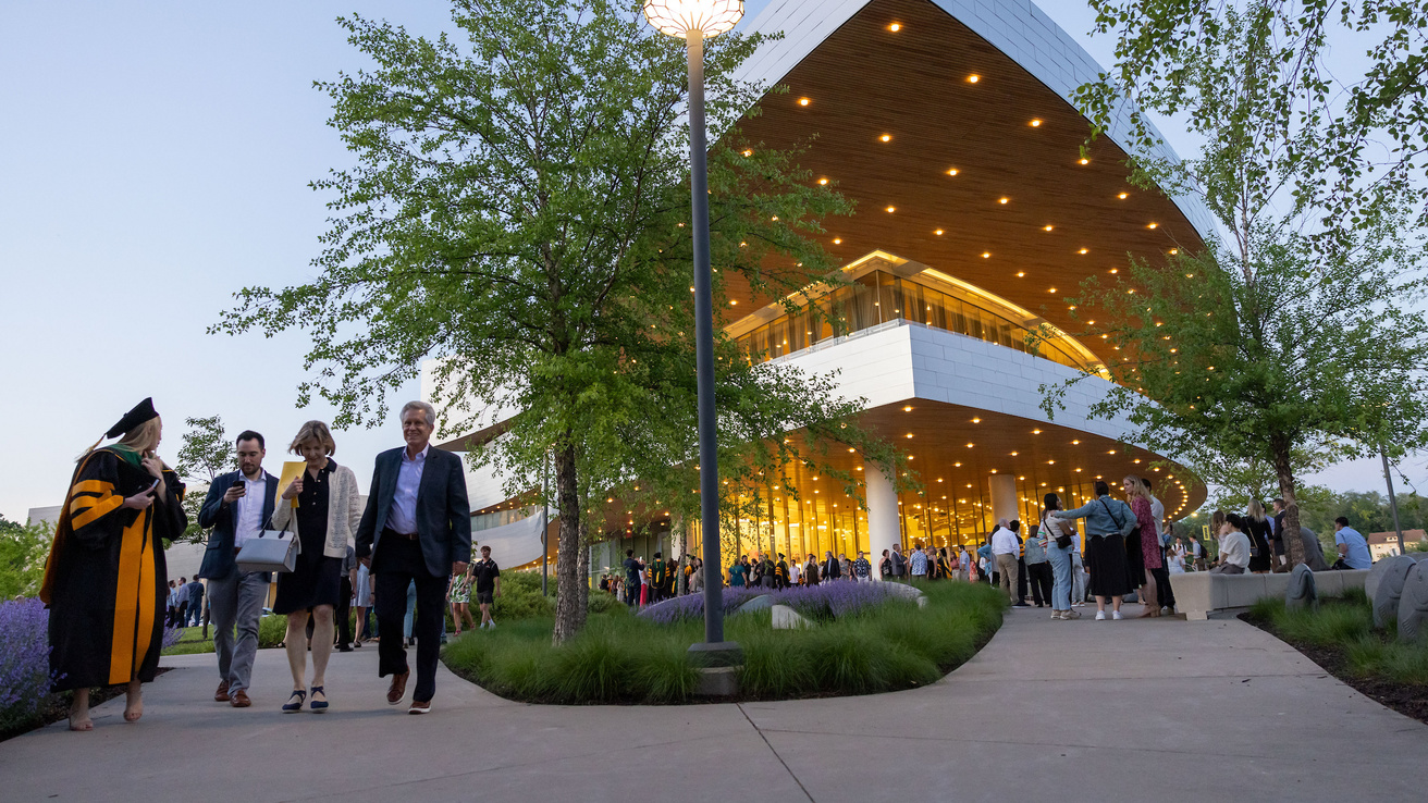 People celebrating outside Hancher Auditorium after the College of Medicine commencement ceremony